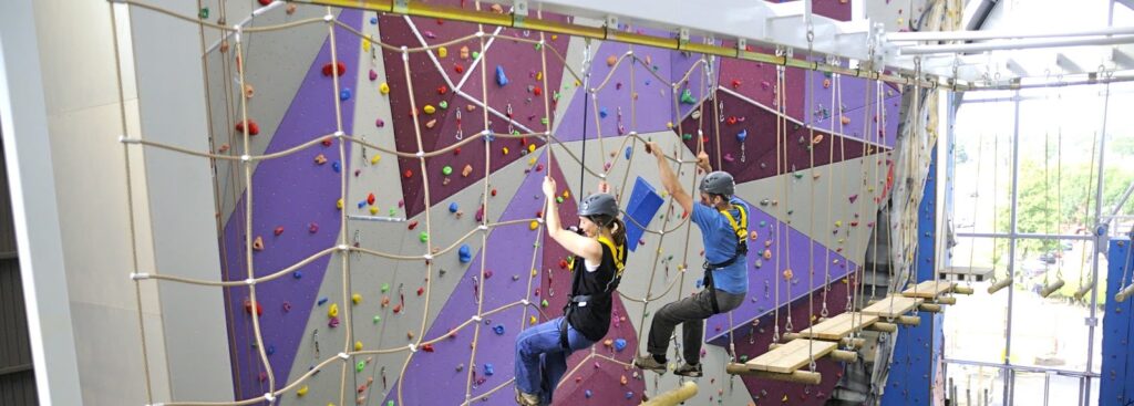 Indoor rope course safety harness system